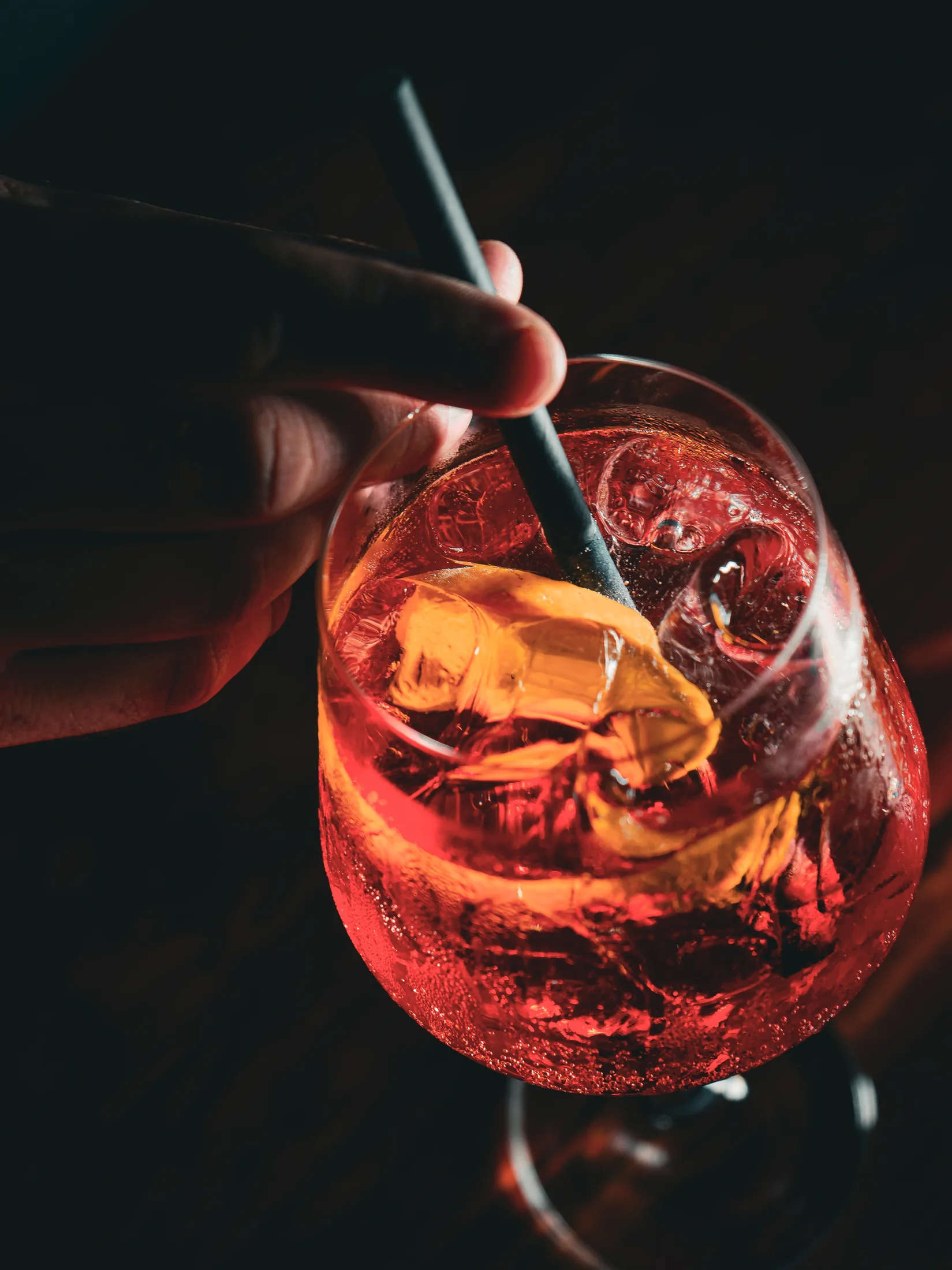 A red cocktail being stirred at Fox Bros Du